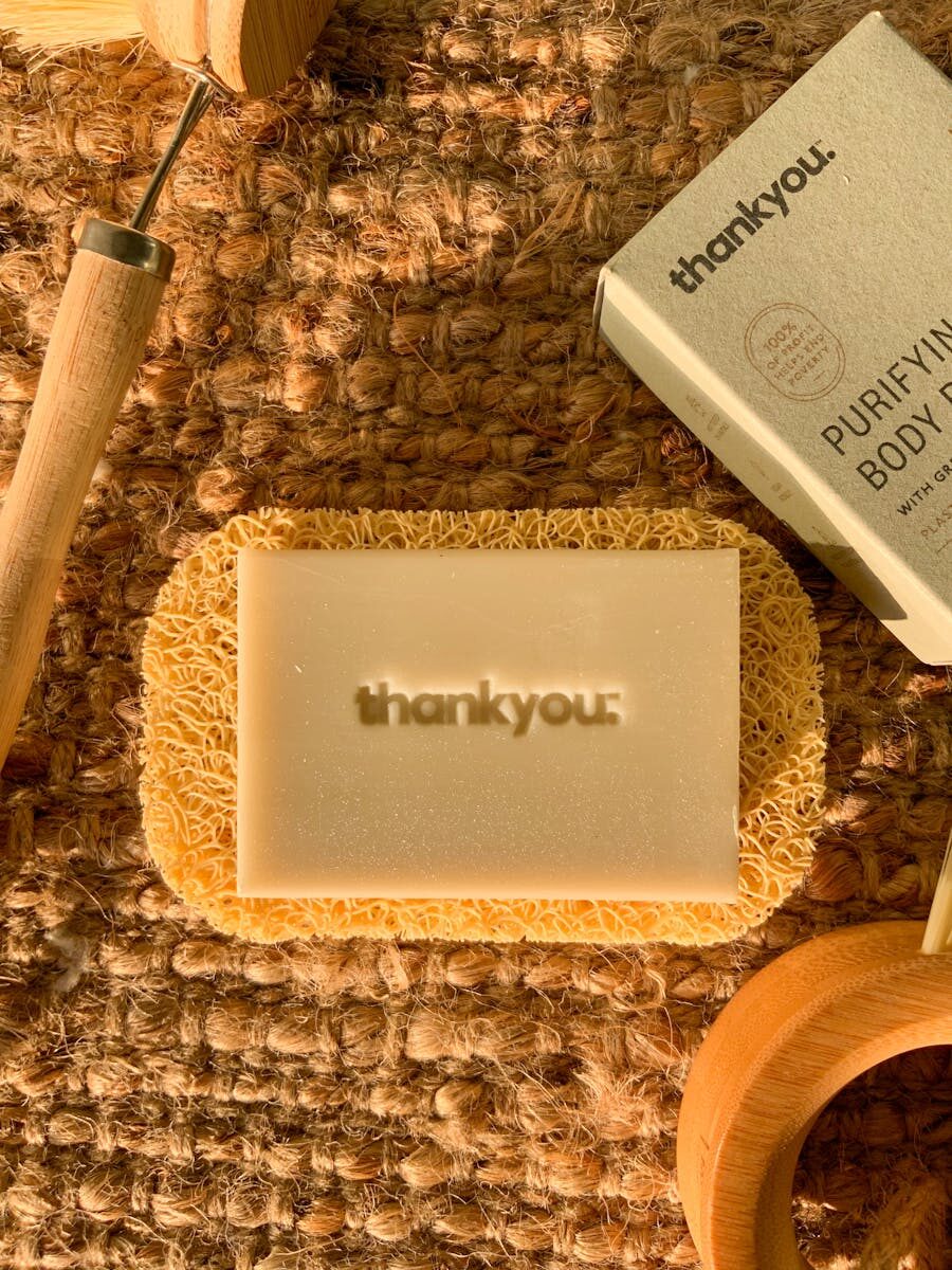 Handmade natural soap on a coir mat with eco-friendly packaging, perfect for sustainable skincare.