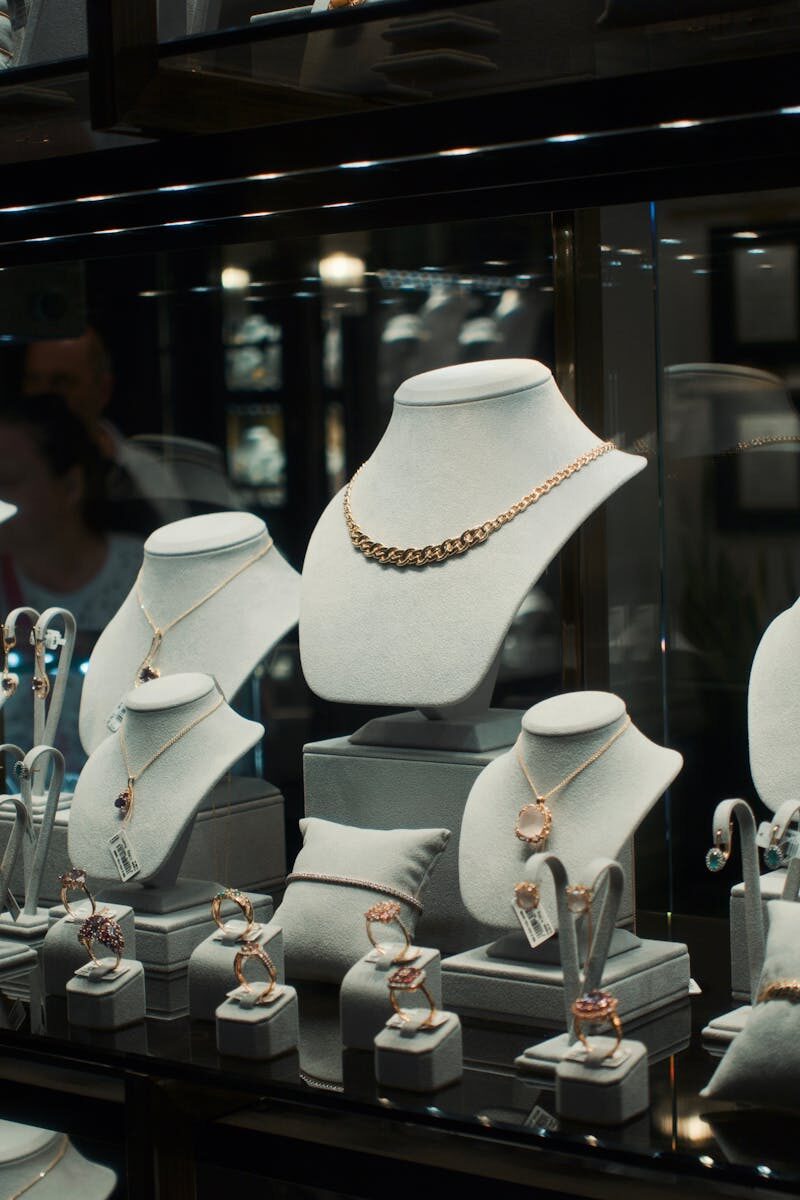 Elegant jewelry pieces elegantly arranged in a retail display case.