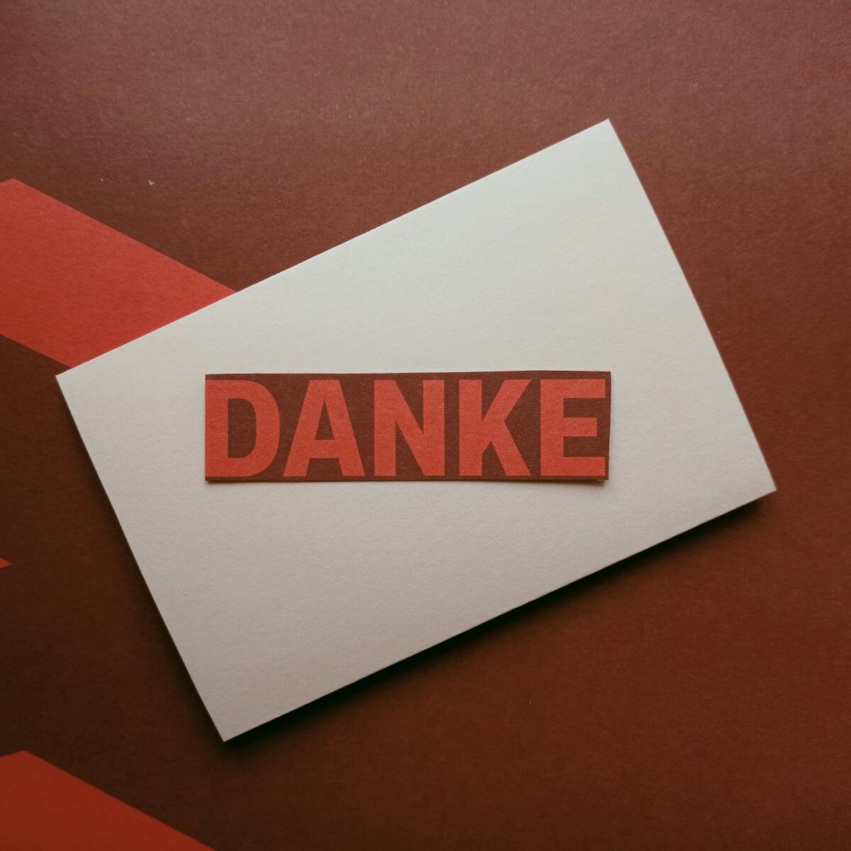 A minimalist 'Danke' thank you card on a textured background, perfect for expressing gratitude.